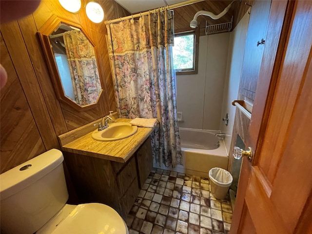 bathroom featuring toilet, wooden walls, vanity, and shower / tub combo with curtain