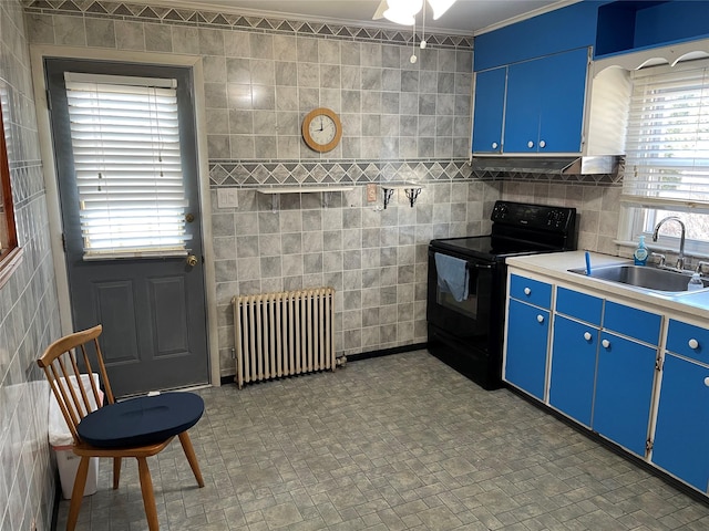 kitchen featuring radiator heating unit, tile walls, a sink, and electric range