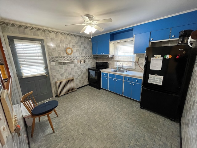 kitchen featuring a sink, light countertops, blue cabinetry, black appliances, and radiator heating unit