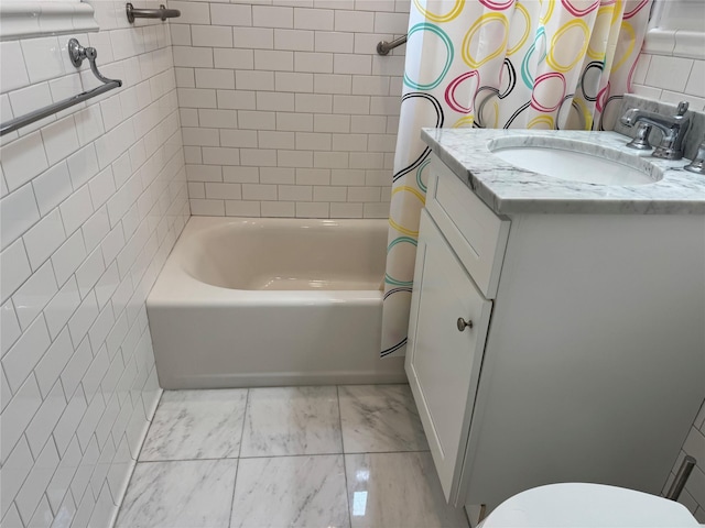 555 Broadway Ave Unit 1H, Hastings-On-Hudson, NY 10706 - full bath with marble look tiles, vanity, tile walls, and shower / tub combo