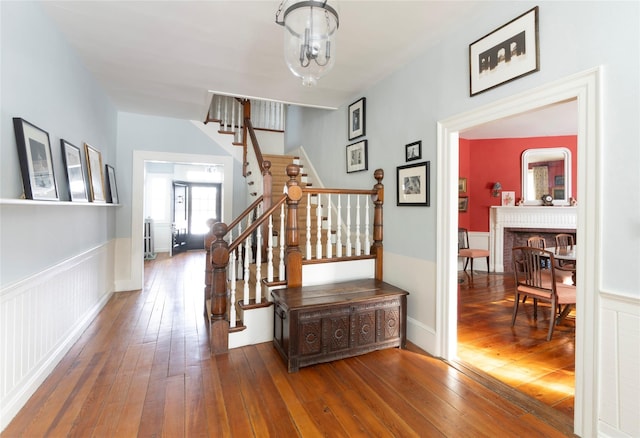 staircase featuring a fireplace and hardwood / wood-style floors