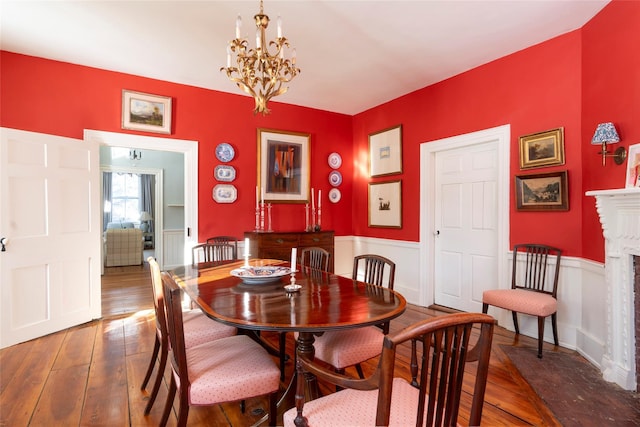 dining room with dark hardwood / wood-style floors and a notable chandelier