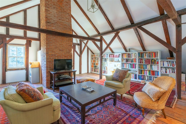 living room featuring vaulted ceiling with beams and hardwood / wood-style floors