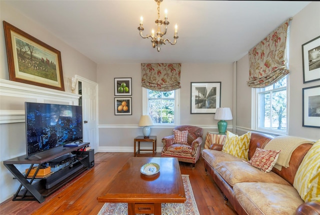 living room featuring an inviting chandelier and dark hardwood / wood-style flooring