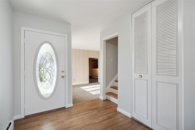 foyer featuring a baseboard heating unit and hardwood / wood-style flooring