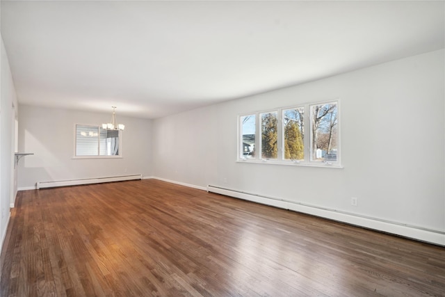 empty room featuring a notable chandelier, a baseboard radiator, and hardwood / wood-style flooring