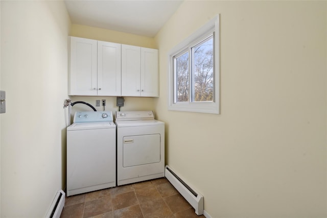 washroom with baseboard heating, washing machine and clothes dryer, and cabinets