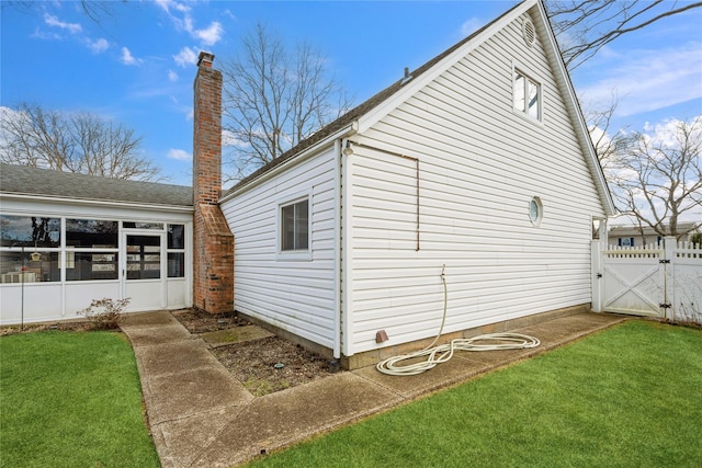 view of side of home with a yard