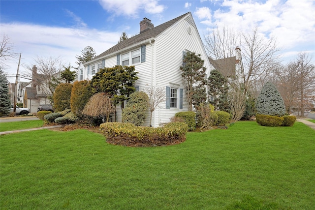 view of property exterior with a lawn and a chimney