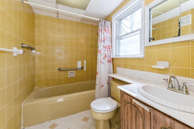 bathroom featuring vanity, shower / bath combination with curtain, toilet, and tile patterned flooring