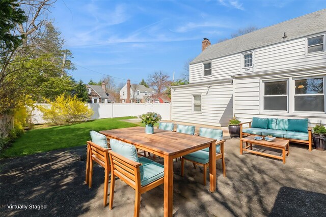 view of patio / terrace with a fenced backyard, outdoor dining area, and an outdoor living space