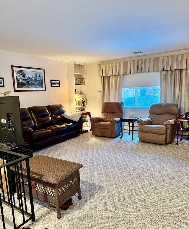 carpeted living area with a baseboard radiator and visible vents