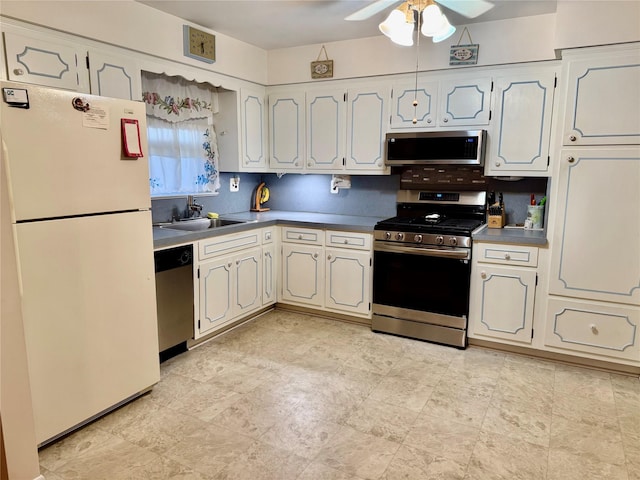 kitchen with white cabinetry, a ceiling fan, stainless steel appliances, and a sink