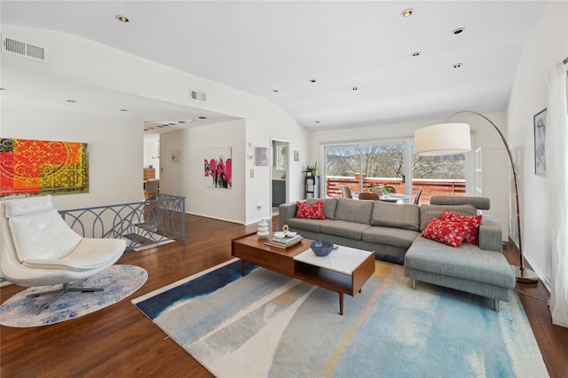 living area with visible vents, vaulted ceiling, and dark wood-type flooring