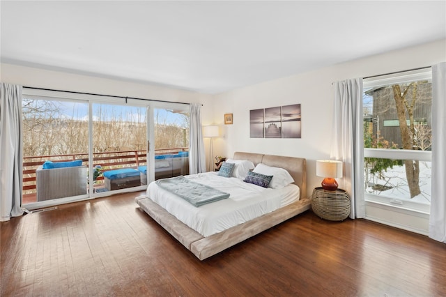 bedroom featuring access to exterior and dark wood finished floors