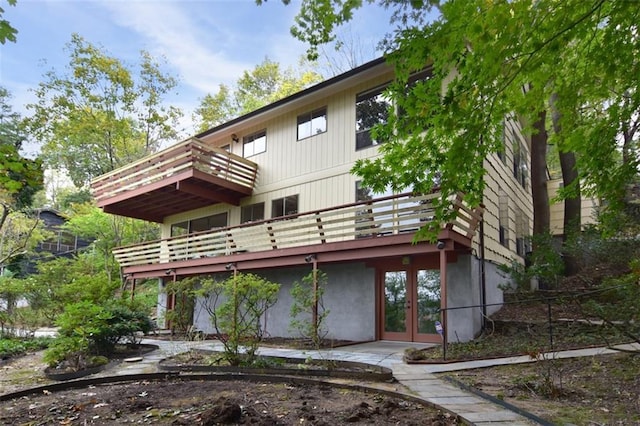 rear view of house featuring french doors and a wooden deck