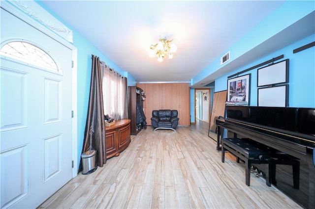 foyer featuring a chandelier and light wood-type flooring