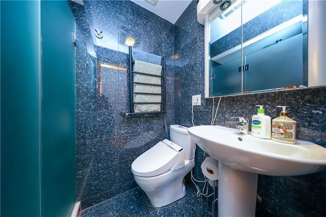 bathroom featuring tile walls and toilet