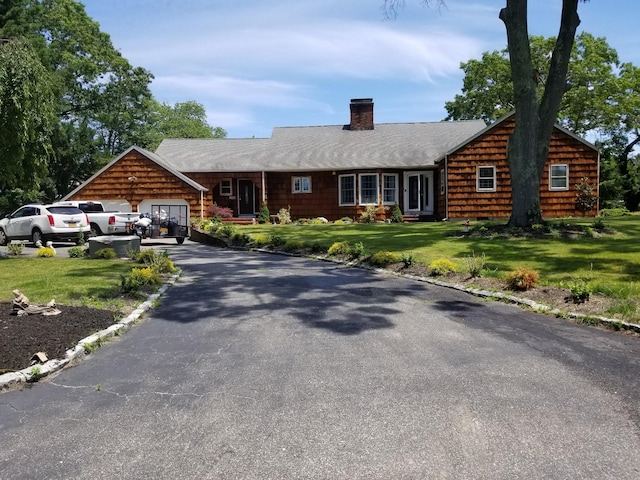 view of front of property with a garage and a front yard