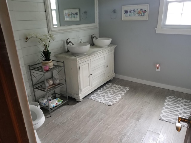 bathroom with vanity, hardwood / wood-style flooring, and toilet