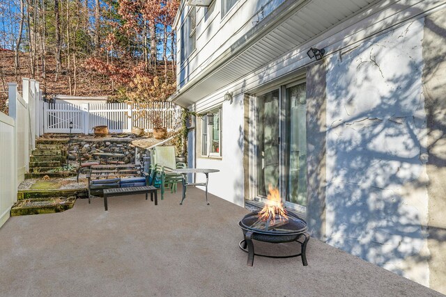 view of patio / terrace featuring an outdoor fire pit