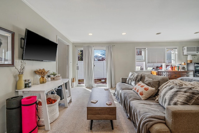 carpeted living room featuring an AC wall unit and ornamental molding