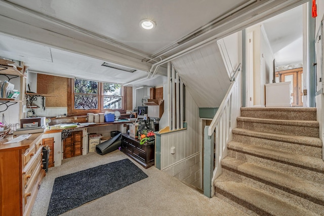 interior space with a workshop area and light colored carpet