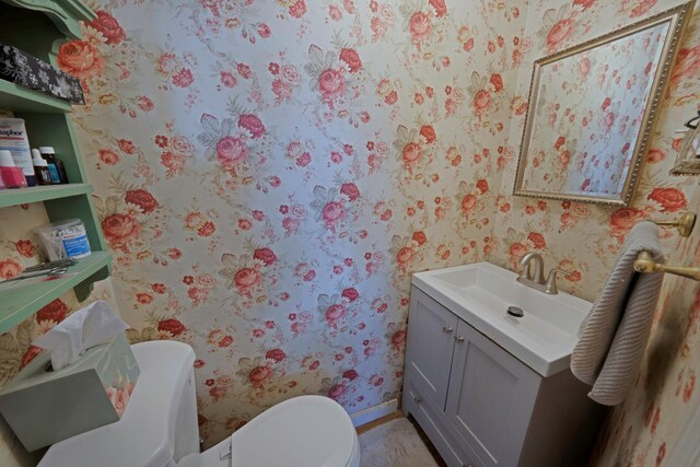 bathroom featuring toilet and vanity