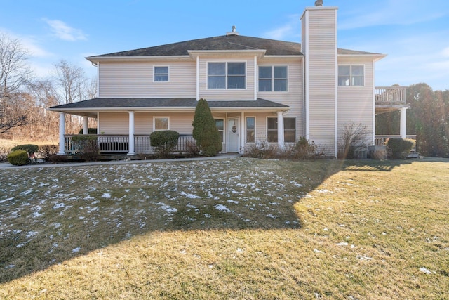 back of house featuring a porch and a yard