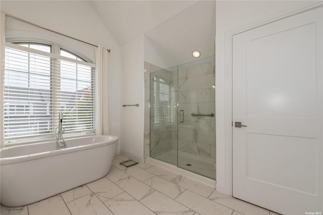 bathroom with plenty of natural light, separate shower and tub, and vaulted ceiling