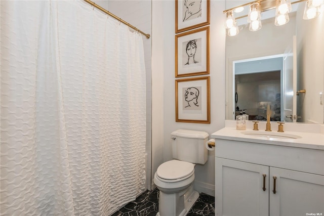 bathroom with vanity, toilet, and walk in shower