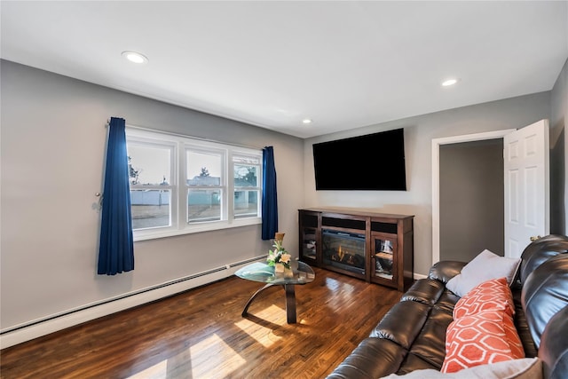 living room featuring a baseboard radiator, a glass covered fireplace, dark wood finished floors, and recessed lighting