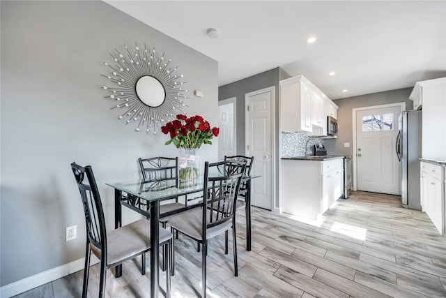 dining area featuring light wood-type flooring, baseboards, and recessed lighting