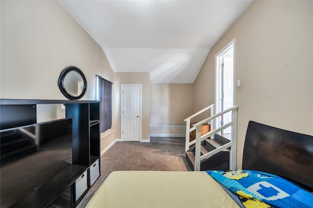 carpeted bedroom featuring lofted ceiling and baseboards