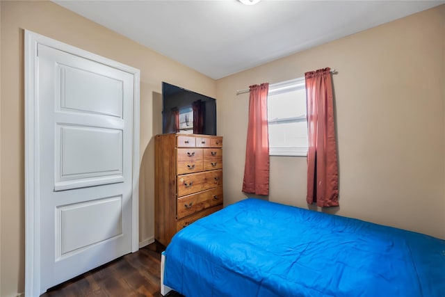 bedroom with dark wood-style floors