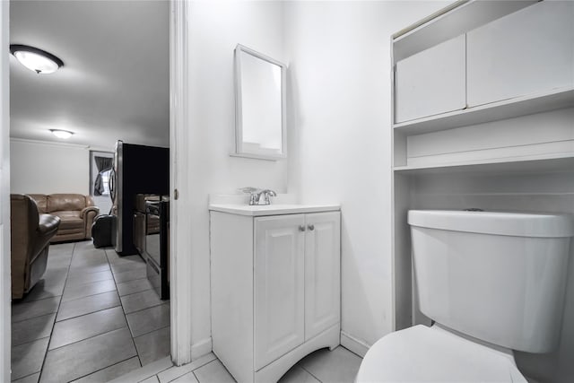 bathroom featuring toilet, tile patterned flooring, and vanity