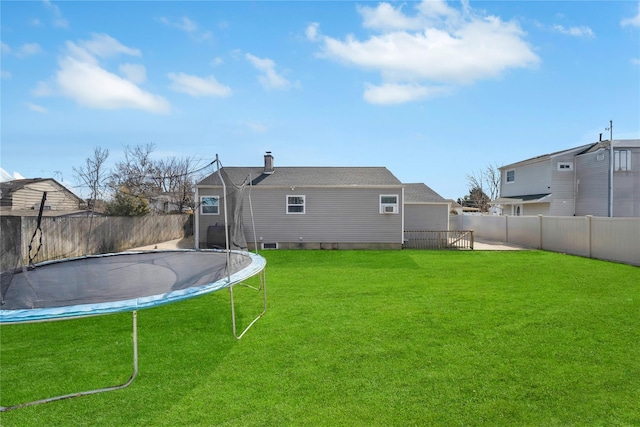 view of yard with a fenced backyard and a trampoline