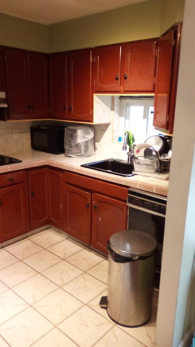 kitchen with extractor fan, sink, decorative backsplash, and black appliances