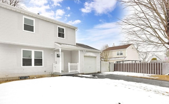 snow covered property featuring a garage