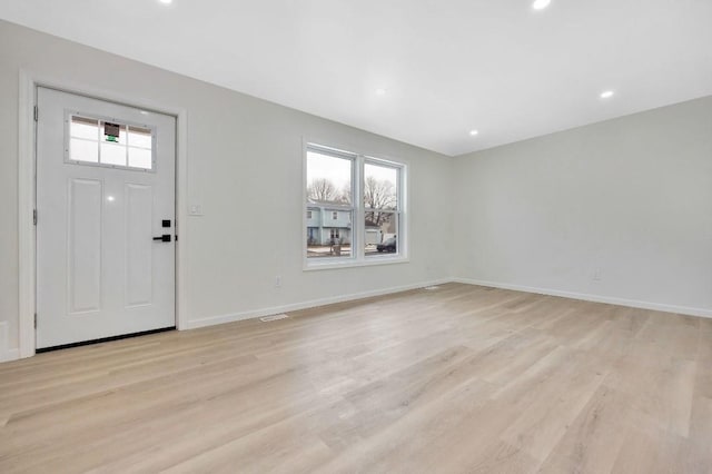 foyer entrance featuring plenty of natural light and light wood-type flooring