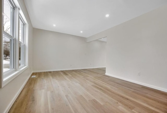 unfurnished room featuring plenty of natural light and light wood-type flooring