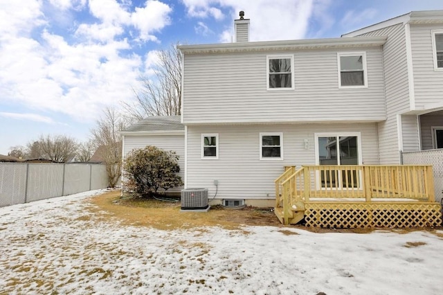 snow covered property featuring cooling unit and a deck