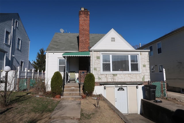 11551 209th St, Cambria Heights, NY 11411 - view of front facade with a chimney and fence