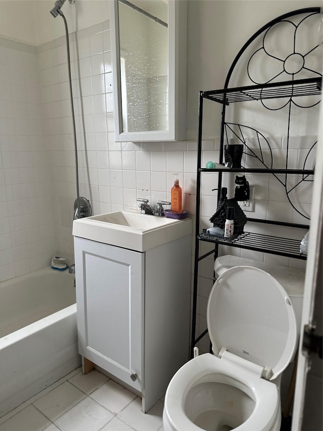 11551 209th St, Cambria Heights, NY 11411 - bathroom with backsplash, vanity, shower / bathtub combination, tile patterned flooring, and tile walls