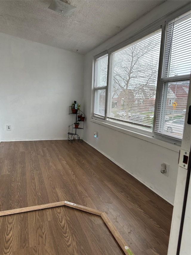 11551 209th St, Cambria Heights, NY 11411 - unfurnished room featuring a textured ceiling and wood finished floors