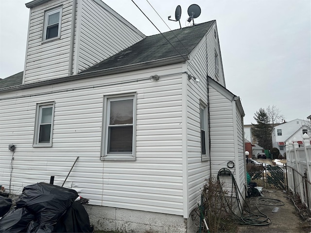 11551 209th St, Cambria Heights, NY 11411 - view of side of home with roof with shingles and fence