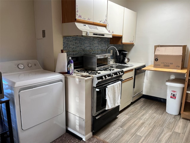 kitchen featuring washer / dryer, light countertops, gas range oven, under cabinet range hood, and dishwasher