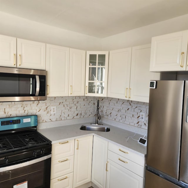 200-21 Hollis Ave, Saint Albans, NY 11412 - kitchen featuring sink, appliances with stainless steel finishes, white cabinetry, light stone countertops, and decorative backsplash