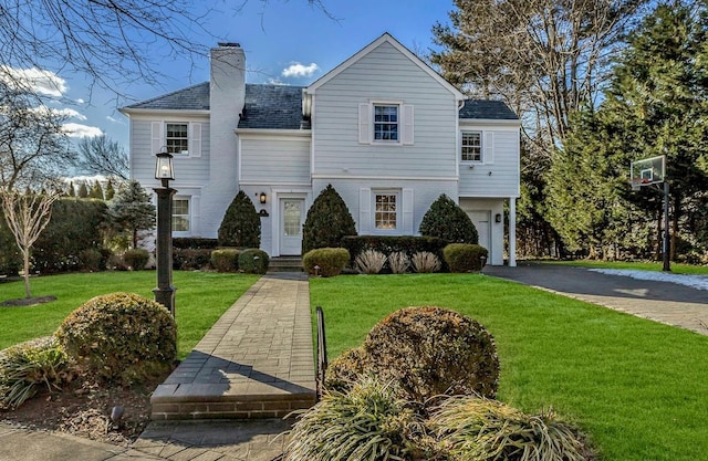 view of front facade with a garage and a front lawn