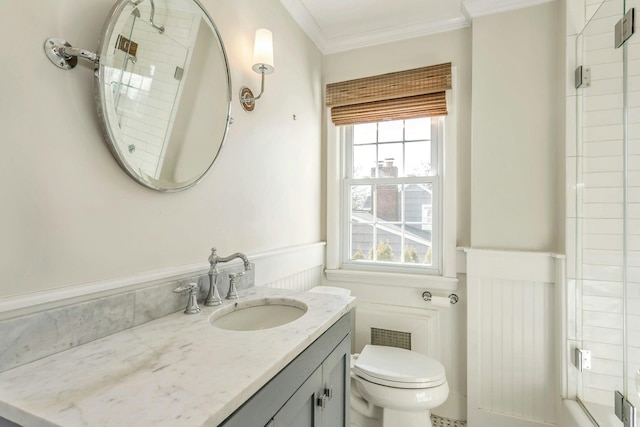 bathroom featuring toilet, vanity, ornamental molding, and walk in shower